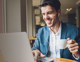 man smiling looking at laptop